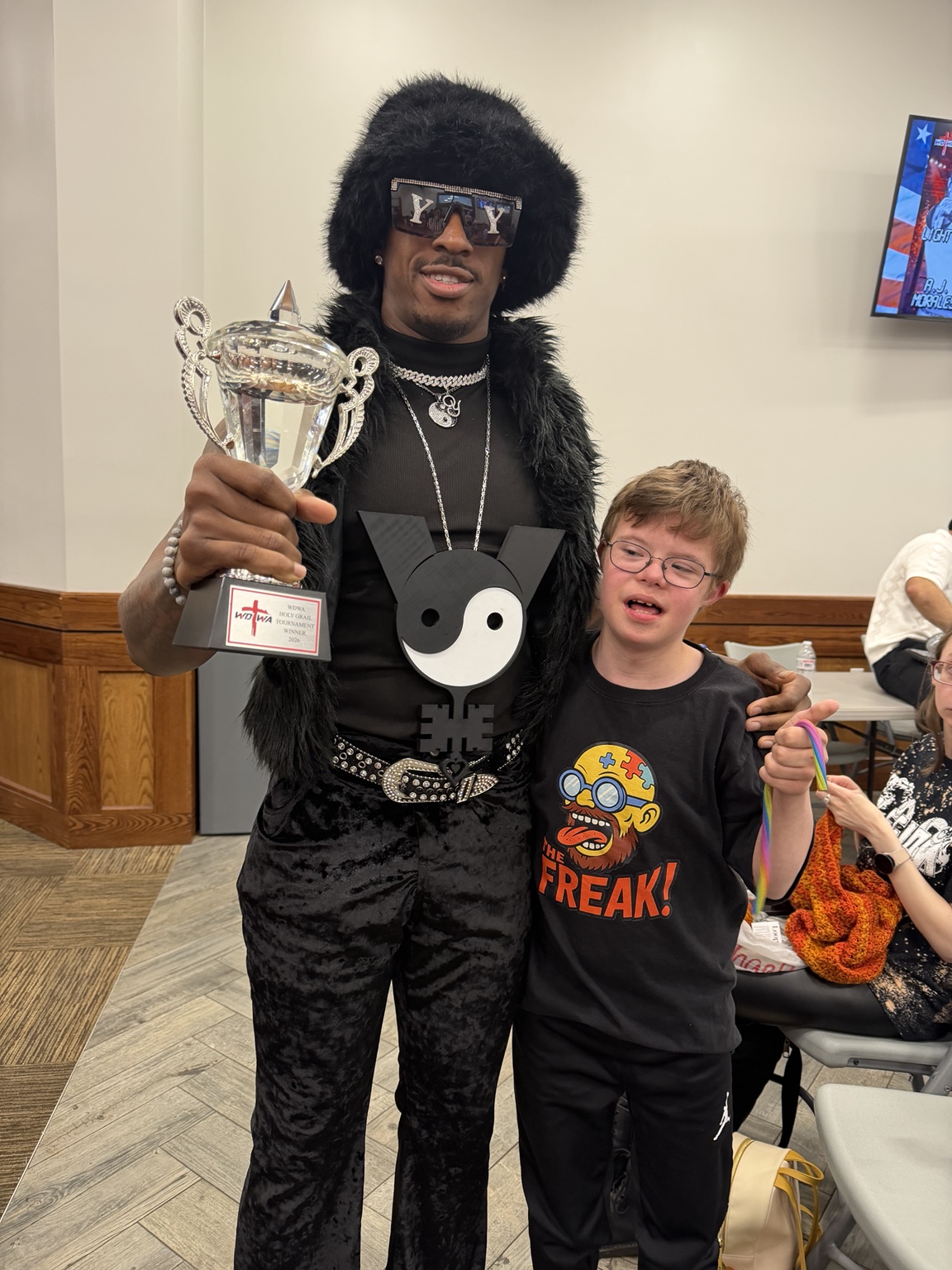 YKies with a fan and trophy
